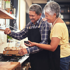 an old couple in the kitchen, cooking